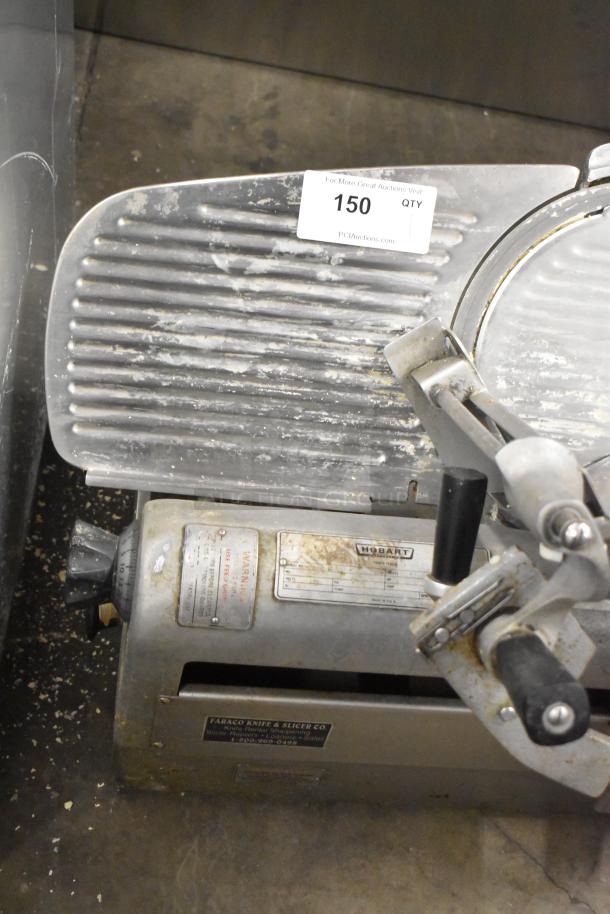 Hobart 1712 Metal Commercial Meat Slicer. 115 Volts, 1 Phase, visible wear, Hobart branding on label, industrial handle.
