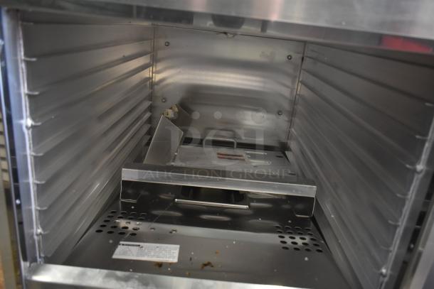 Brand new Avantco heated holding cabinet; metal construction, commercial casters; 120V, 1 phase; slight scratches and dents visible.