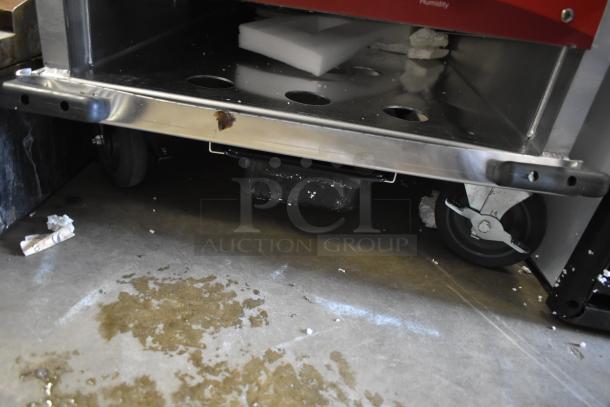 Brand new Avantco heated holding cabinet, metal construction, 120V, visible scratches, dented, on commercial casters.