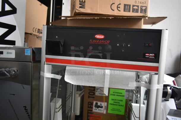 Brand new Hatco Flav-r-savor metal countertop heated holding cabinet, minor scratches and dents visible, model details on panel.