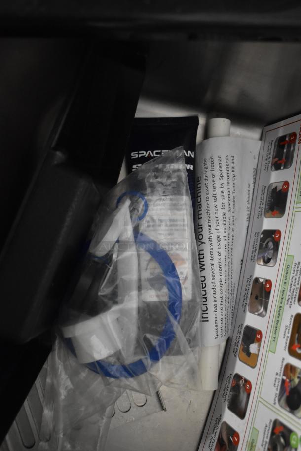 Stainless steel Spaceman 6210-C soft serve machine accessories and manual. New, with bagged parts and instructional materials.