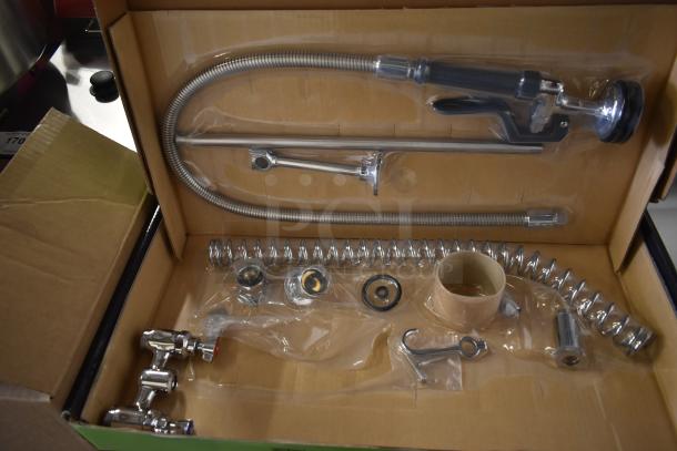 Brand new Regency 600PRD4X wall mount 8" center pre-rinse faucet in box, includes hose, valve, and fittings. Scratch and dent.
