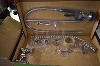 Brand new Regency 600PRD4X wall mount 8" center pre-rinse faucet in box, includes hose, valve, and fittings. Scratch and dent.