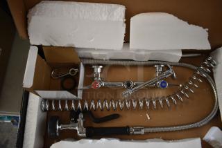 Brand new Regency 600PRW8X wall-mounted pre-rinse faucet, 1.15 GPM, 8" centers, 44" hose, minor cosmetic scratches, boxed.