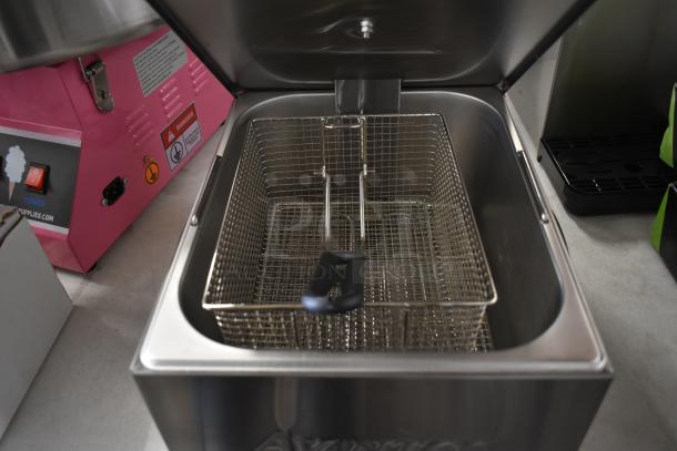 Brand new Avantco 177F100 stainless steel 10 lb. electric countertop fryer with metal fry basket and lid; visible controls.