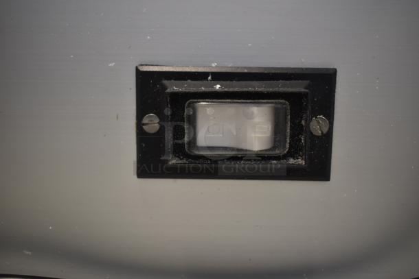 Black switch on the Sirman GF Dakota 20021608WNA electric cheese grater, 120 volts, 1 phase, shown with housing screws.