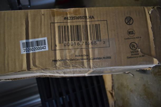 Cardboard box with barcode and model #423SW60TLHA for ServIt 60" strip warmer, marked scratch and dent, UL and NSF certifications visible.