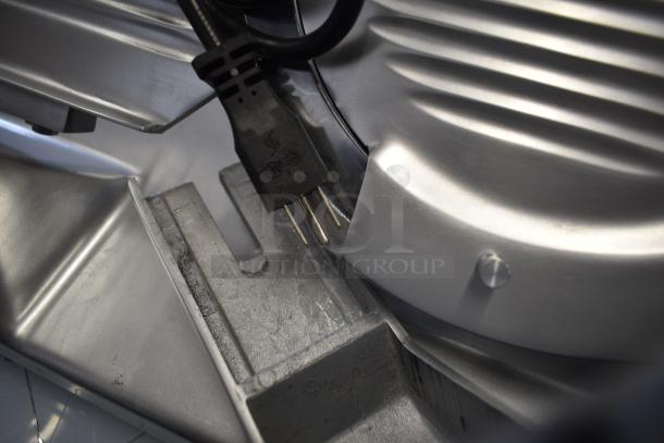 Stainless steel Hobart EDGE10-11 manual meat slicer, new scratch and dent, with blade sharpener and 115V plug.