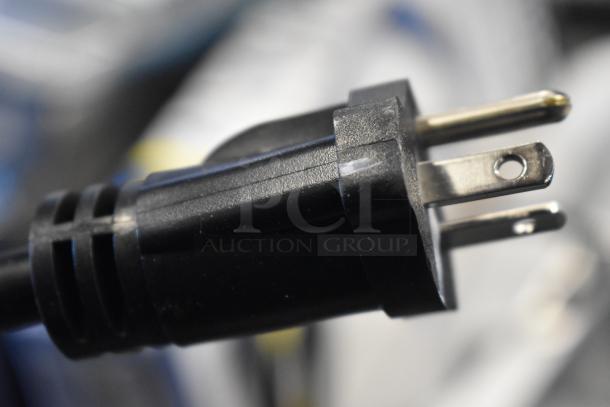 Close-up of a black plug for a Hatco TQ-800HBA stainless steel commercial toaster, showing three-prong design.