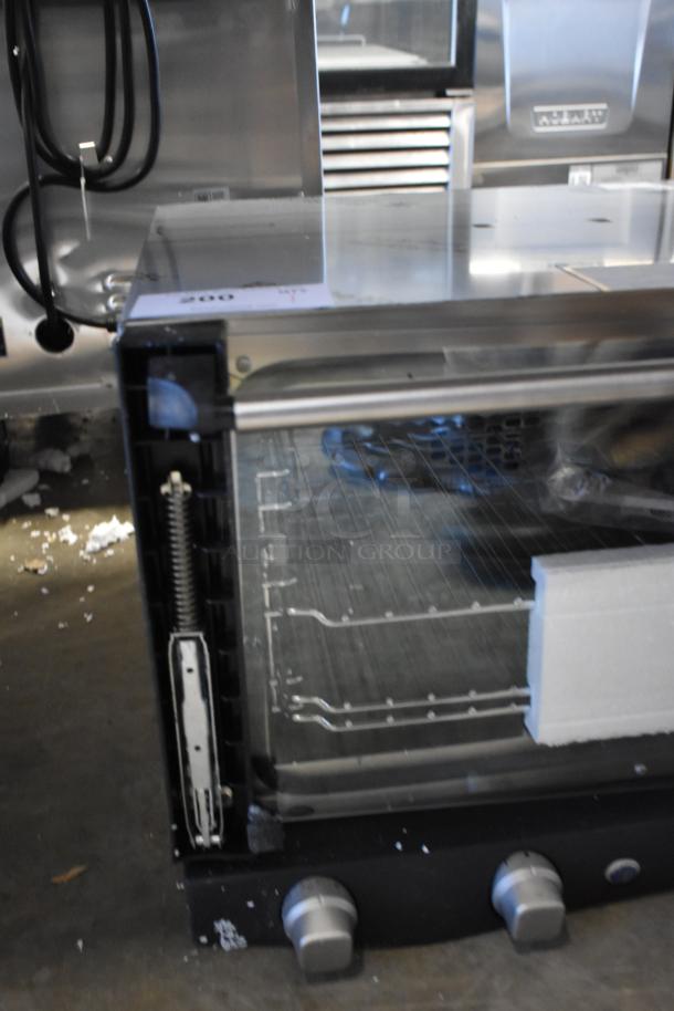 Brand new scratch and dent Cadco XAF013-US stainless steel convection oven, 120V, 1 phase, commercial countertop model.