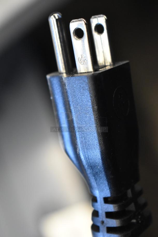 Close-up of a three-prong power plug for the Cadco XAF013-US convection oven, rated at 120 volts, 1 phase.