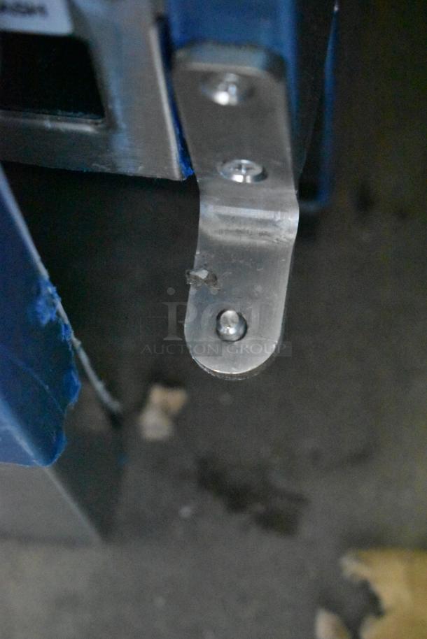 Stainless steel bracket on Hoshizaki AM-50BAK ice machine, showing close-up of mounting detail and minor scratches.