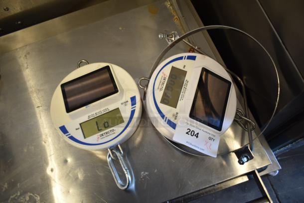 Two Cardinal Detecto SCS30 30 lb. solar-powered hanging scales, with digital displays, hooks, and metal loops; new condition.