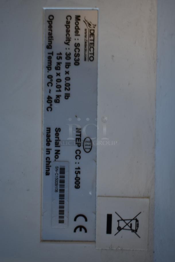 Cardinal Detecto SCS30 scale tag showing 30 lb. capacity, model number, operational temp, and serial number. Made in China.