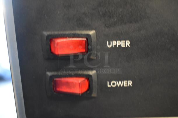 Close-up of Bunn VPR coffee brewer's control panel, showing "Upper" and "Lower" red light indicators.
