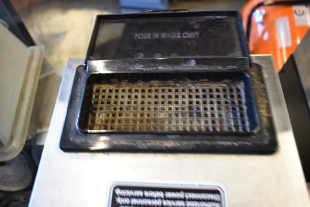 Close-up of a Bunn VPR coffee brewer's water reservoir. Label reads "Pour in Water Only." Slight wear visible.
