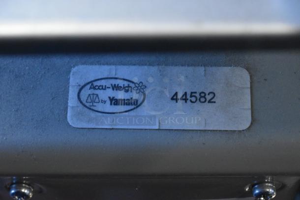 Metal countertop scale by Accu-Weigh, model 44582. Features a sturdy design; visible label indicates brand and model.