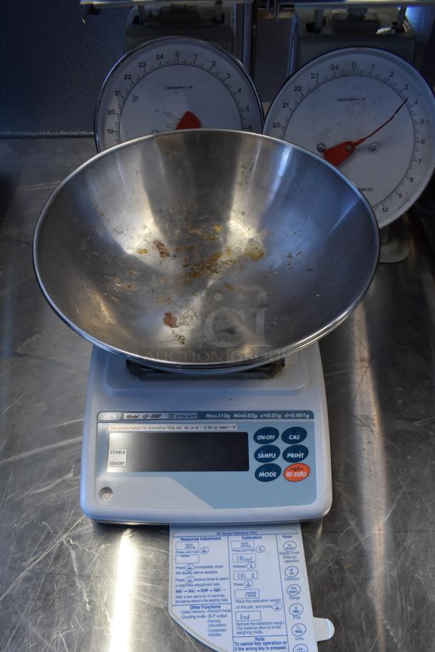 AND GF-300P metal countertop scale with digital display and control buttons. Includes instruction card. Used condition.