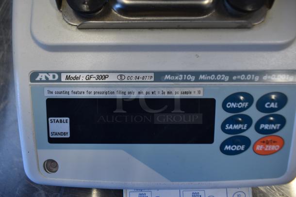 AND GF-300P metal countertop scale, clear display, max 310g, min 0.02g, buttons for calibration, sample, print.