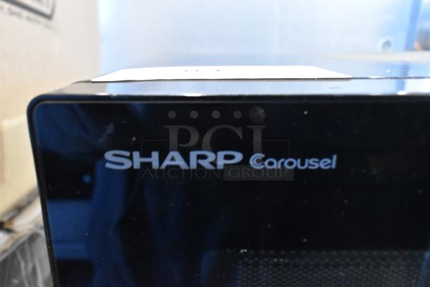 Sharp SMC1131CB countertop microwave oven, black finish, includes plate, 120 volts, 1 phase, good condition.