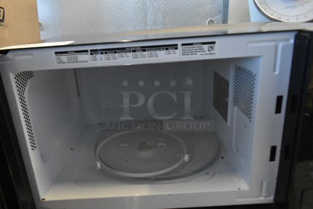 Sharp SMC1131CB Countertop Microwave Oven, with plate, visible wear inside, 120 Volts, 1 Phase. Interior labels shown.