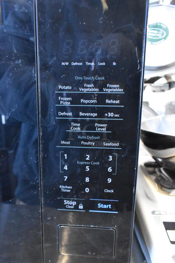 Sharp SMC1131CB Countertop Microwave Oven, black, with touchpad controls. Includes plate, operates at 120 volts, 1 phase.