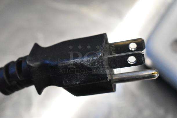 Close-up of a power plug for the Sharp SMC1131CB Countertop Microwave Oven, suitable for 120 volts, single phase.