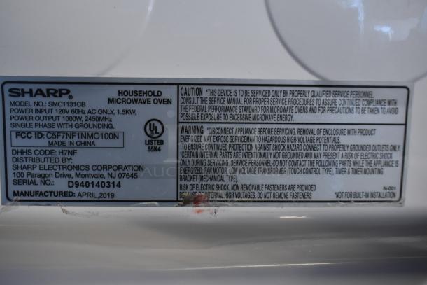 Sharp SMC1131CB countertop microwave oven label. Displays model, power input 120V, output 1000W, UL listed. Manufactured April 2019.