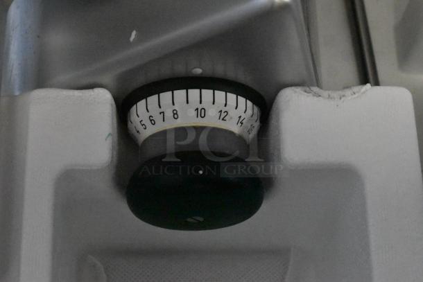 2023 Bizerba GSP HD slicer part, showing a numbered dial for thickness adjustment. Heavy-duty, automatic, 13" blade.