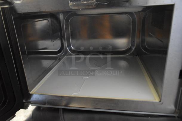 2021 Amana RCS10TS stainless steel commercial microwave, interior view with visible crack on the bottom surface.