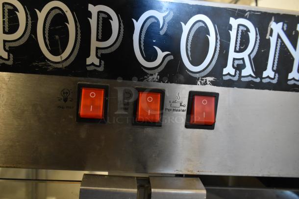 Metal commercial popcorn maker with "POP" text, three switches labeled "Warmer," "Stirrer," and "Pot Heater." 115 volts, 1 phase.