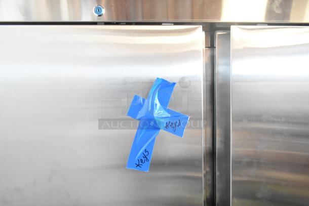 Avantco Stainless Steel Commercial 2 Door Reach In Cooler with blue tape marked "Keys," 115 volts, 1 phase.