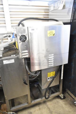 Belshaw Adamatic TG-50 stainless steel thermoglazing station, commercial casters, labeled for 208V, 1-phase use.