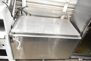 Stainless steel commercial washing/soaking tub, large capacity, sturdy build, minor surface wear, ID tag visible.