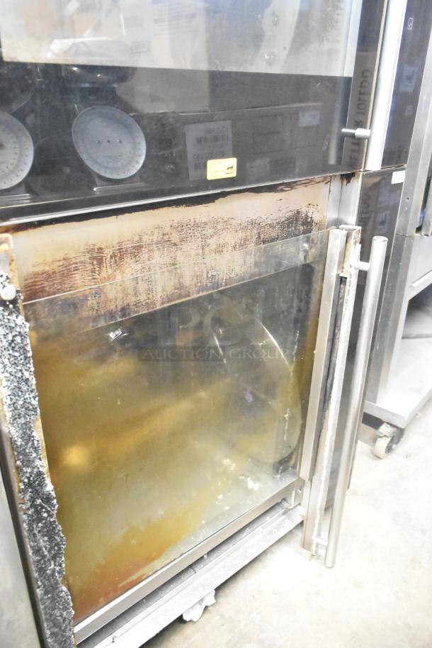 Fri-jado TDR7+7 P stainless steel rotisserie oven with visible broken glass on bottom. Electric, 208V, 3-phase.