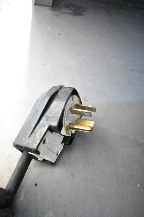 Plug of Fri-jado TDR7-P electric rotisserie oven, showing three-prong design for 208V, 3-phase compatibility.