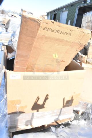 Large cardboard box containing four brand new scratch and dent items. Includes gray posts, Carlisle sneeze guard, Bakers Lane ingredient bin, and ice bin. Visible markings: "WASH BEFORE U."