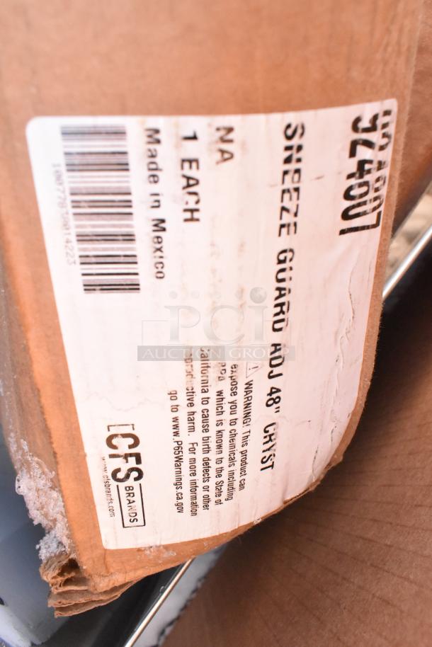 Close-up of packaging label for Carlisle Sneeze Guard, adjustable 48", by CFS Brands, showing product warnings and made in Mexico.