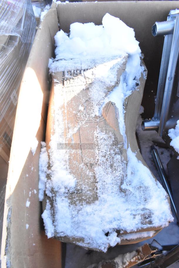 Cardboard box with snow, containing brand new scratch and dent items: gray posts, Carlisle sneeze guard, Bakers Lane ingredient bin, ice bin.