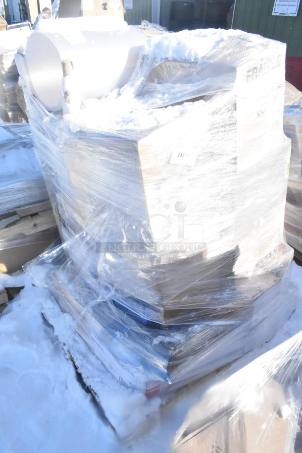 Large pallet of assorted scratch and dent items, including mop heads, filter, scrub brush, wrapped in plastic, snow covered.