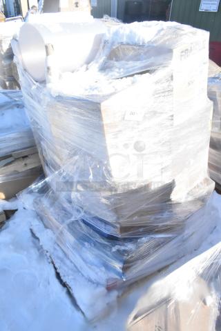 Large pallet of assorted scratch and dent items, including mop heads, filter, scrub brush, wrapped in plastic, snow covered.