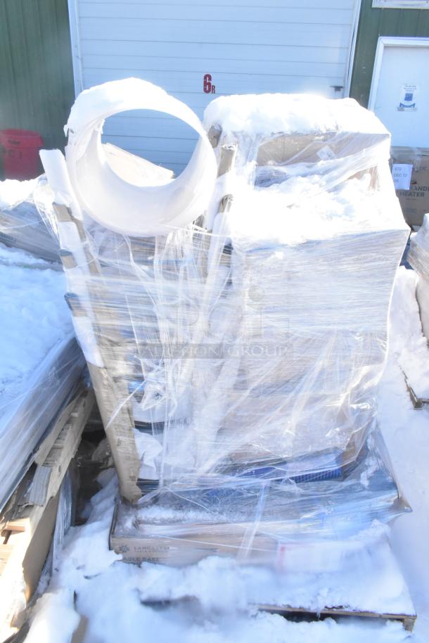 Shrink-wrapped pallet with 9 new scratch and dent items, including filter, mop heads, scrub brush, in snowy setting.