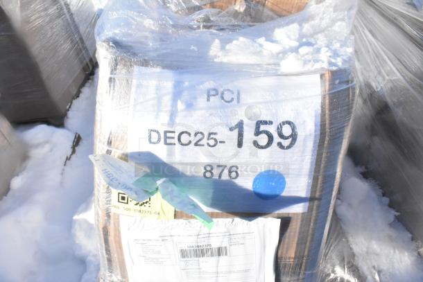Pallet with "PCI DEC25-159 876" label, wrapped in plastic, on snow. Shipping documents visible. Auction contents include scratch and dent items like tabletops and woks.