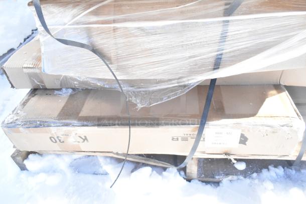 Sealed boxes of new scratch and dent items; visible labels show shipping details. Items include Hatco warming drawer, Avantco shelf.