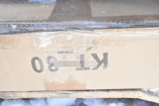 Cardboard box labeled "KT-30" on a snowy pallet, containing 8 new scratch and dent items, including Hatco warming drawer.