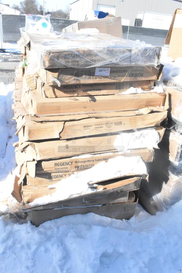 Stack of boxed Regency 16-gauge work tables, scratch and dent condition, labels indicate model 30x48 and 30x72.
