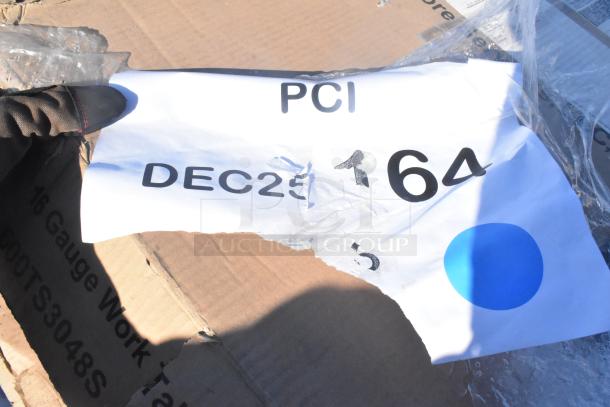 Alt text: Cardboard box with partially visible label "PCI DEC25 164" and "16 Gauge Work Table" printed on side.