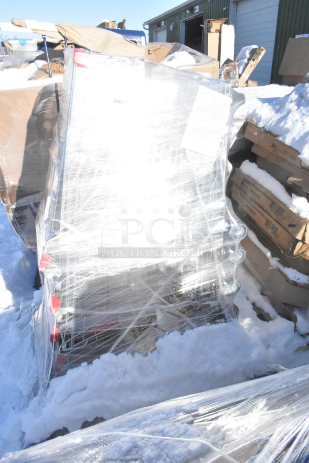 Brand new metal shopping carts wrapped in plastic, showing mild scratch and dent. Snow around pallets.