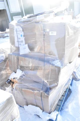 Plastic-wrapped pallet containing six brand new scratch and dent items, including a sink, chair, and barstool, on a snowy ground. Tags indicate labels with numbers and codes.