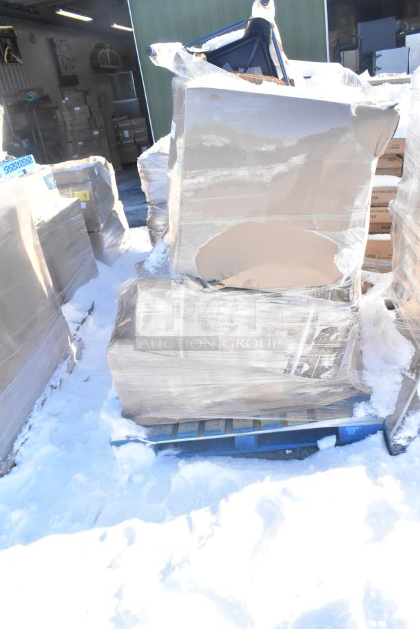 Pallet containing six brand new scratch and dent items, wrapped in plastic, including a sink, chair, and barstool, in storage.